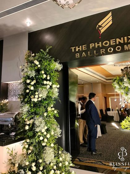 Another shot of the grand entrance to the ballroom, where the lush green and white floral towers welcome guests into the magical reception space.
