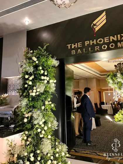 Another shot of the grand entrance to the ballroom, where the lush green and white floral towers welcome guests into the magical reception space.