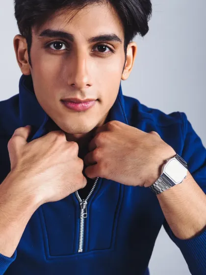 A strong commercial headshot. The focus is on a direct, friendly expression and a clean, marketable look.