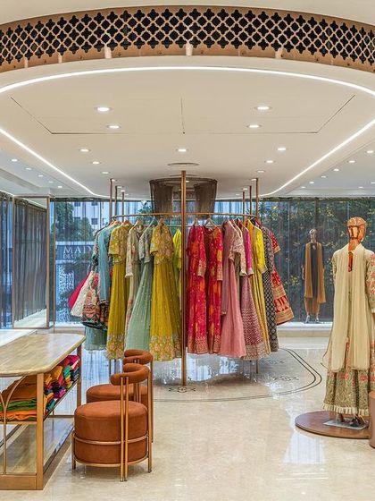 The fourth floor, which houses ready-to-wear collections, features a central circular display. A decorative jaali element in the ceiling adds a touch of traditional craft to the modern space.