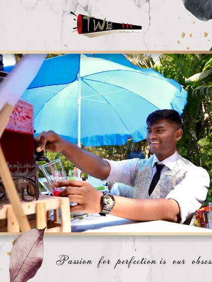 A bartender dispenses a refreshing red mocktail from a large glass dispenser, perfect for keeping guests hydrated in style.