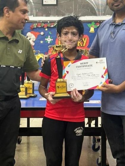 This player's hard work paid off, earning him a trophy and a merit certificate. We celebrate his dedication and achievement.