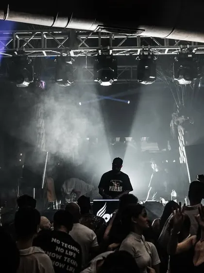 A wide shot of me performing in a large, packed venue. This image showcases my ability to handle big rooms and create an atmosphere that fills the entire space.