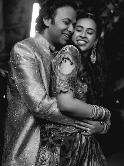 A joyful black and white photo of the couple hugging on the dance floor, lost in their own world.
