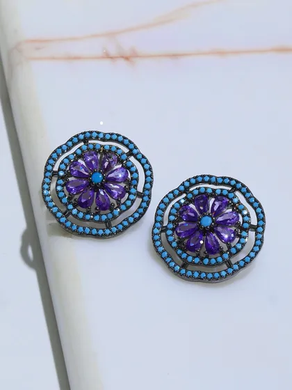 A close-up of the Amethyst and Turquoise stud earrings, showing the detailed craftsmanship of the floral motif.