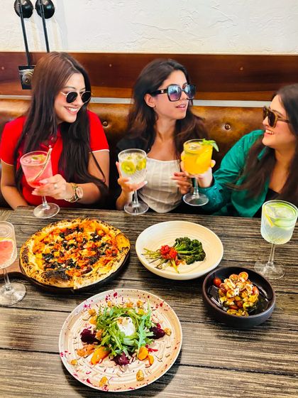 A table full of food, drinks, and friends. This is what celebrating life looks like at my place.