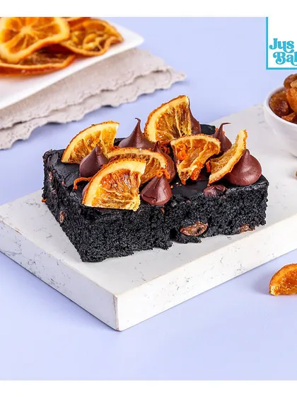For those with dietary restrictions, I offer delicious gluten-free options. This gluten-free and egg-free brownie is rich and fudgy, topped with candied orange slices and raisins.