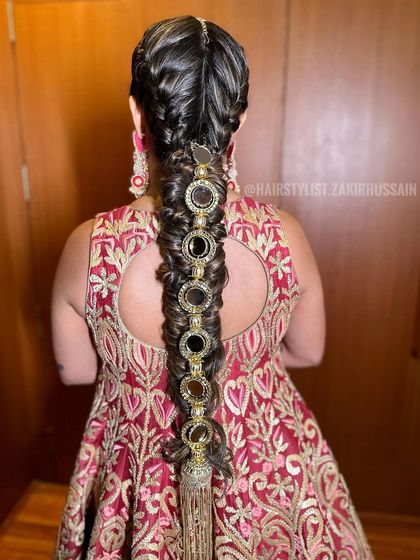 Another angle of the intricate braid with large mirror accessories, showing the detail of the jewelry.