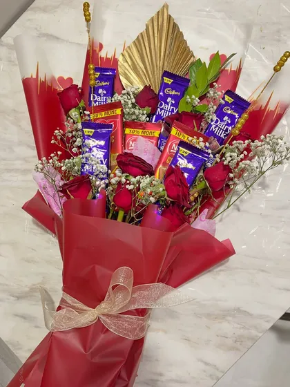 Can't decide between classic romance and a sweet treat? You don't have to. I combine fresh, velvety red roses with an assortment of popular chocolates like Cadbury Dairy Milk for a gift that offers the best of both worlds.