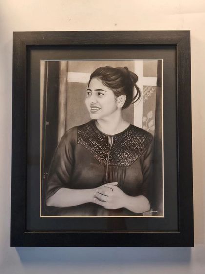 The same portrait in a classic black frame, hung and displayed.