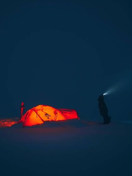 In the deep of a snowy night, a headlamp cuts through the darkness, revealing the glowing tent. When visibility is low, the tent becomes a sanctuary of warmth and safety.