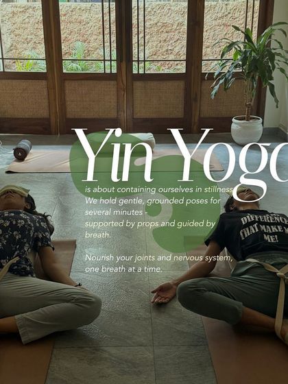 Two participants in a supported, reclined butterfly pose during a Yin Yoga class. This gentle, grounded practice uses props to help nourish the joints and calm the nervous system.