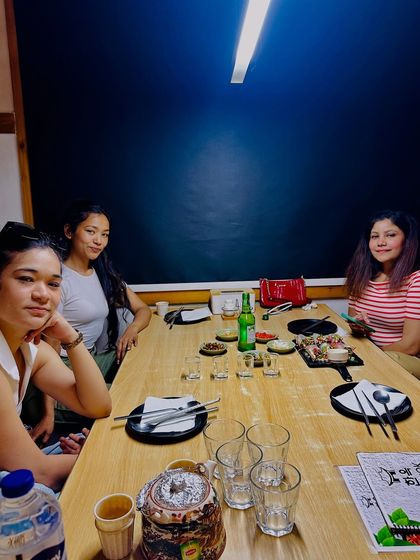 A wider shot of our group enjoying the meal. This shows the restaurant's capacity to host groups and reinforces the social, shared experience of Korean dining.