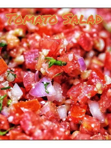 A simple yet classic Tomato Salad with finely chopped onions and fresh coriander, a perfect accompaniment to any meal.