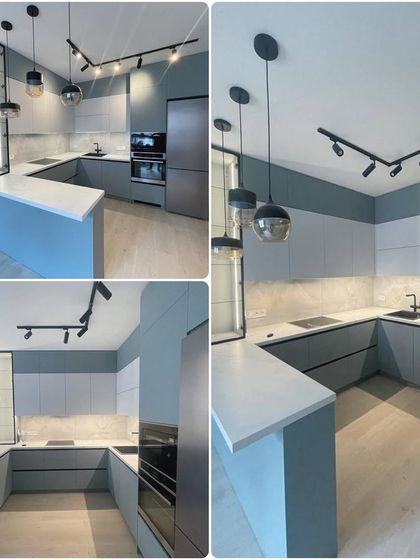Pastel colors create an illusion of a larger, more open space. This kitchen uses a soft blue-grey finish with track lighting and pendant lights to create a modern and airy feel.