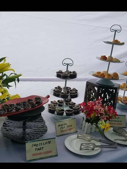 I also handle the desserts to end your party on a sweet note. This is a dessert station I set up, complete with homemade chocolate tarts and mocha cupcakes, all beautifully presented for your guests to enjoy.
