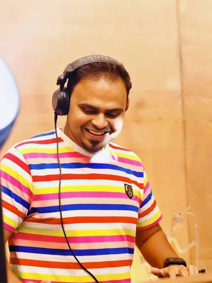 A happy, candid shot of me in a colorful striped shirt, enjoying the music as much as the crowd.