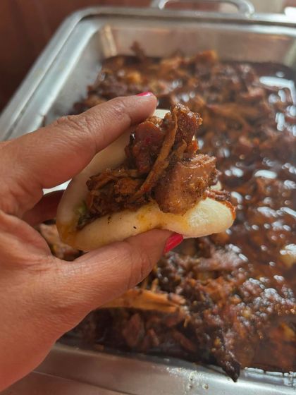 A soft, fluffy bao bun generously stuffed with my signature pulled pork. It's a wonderful snack or appetiser, especially when paired with a refreshing drink.