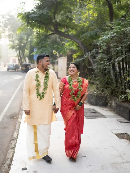 A candid shot of the couple walking together, sharing a happy moment after their ceremony.