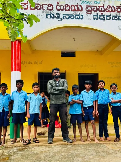 For me, the work is not complete until I see the smiles it brings. Standing with these bright young students in front of their newly painted government school is the greatest reward for my art.