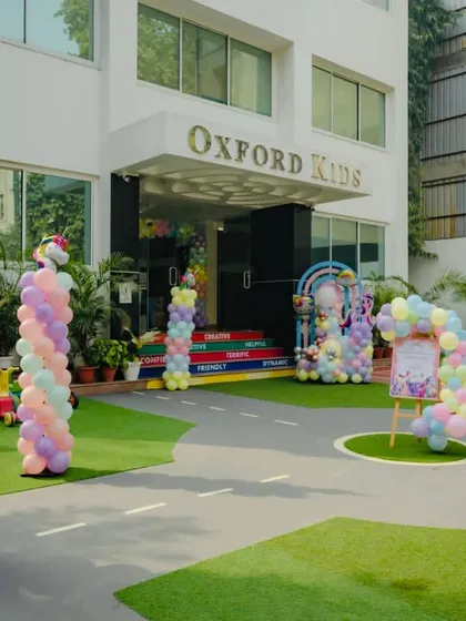 The entrance to Funville decorated with pastel balloon columns and unicorn figures for a My Little Pony party.