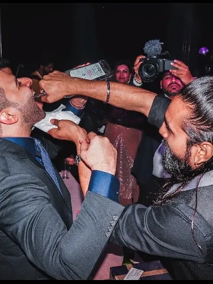 I bring the bar to you. This is a classic 'Dancing Bartender' move, ensuring the groom and his friends are having the time of their lives right on the dance floor.