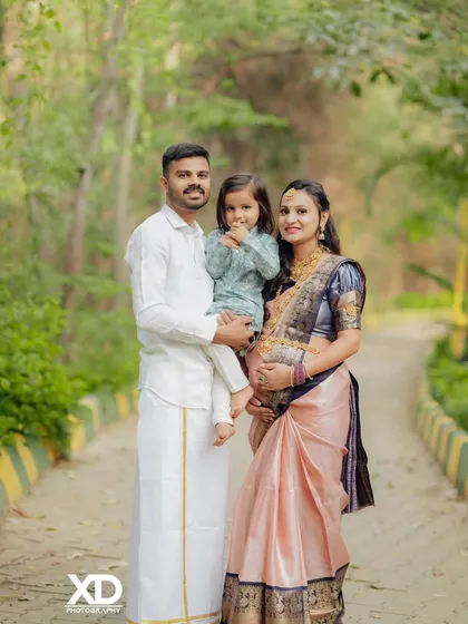 A heartwarming family photo, with the parents and their child sharing a special moment together.