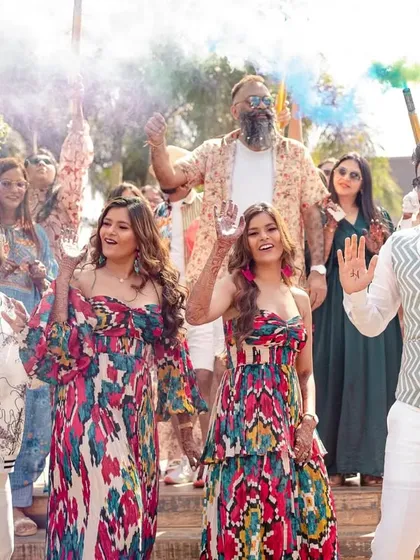 The two couples posing with color smoke bombs, adding a vibrant and dynamic element to their pool party entrance.