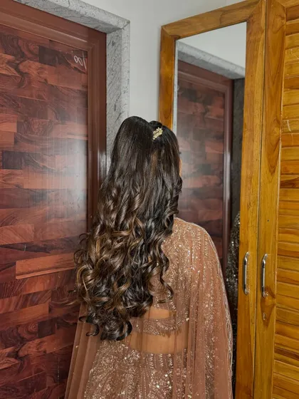 The back view of the sangeet ponytail, showing the beautiful cascade of curls.