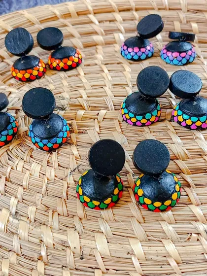 A collection of my colorful terracotta jhumkas. These two-part earrings feature a simple black stud connected to a vibrant, multi-colored dome.