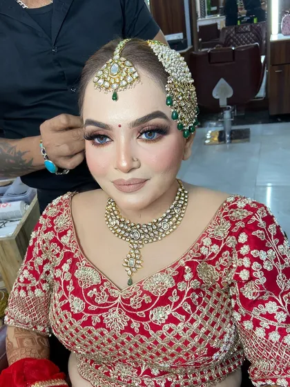 A final look at the bride's makeup before her hair is fully styled. The focus is on creating a perfect canvas that will last all day.