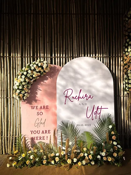 A simple and elegant welcome sign for the wedding, adorned with florals. This is the first touchpoint for guests, and I make sure it's a beautiful one.