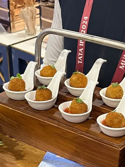 Arancini balls served as pass arounds during an IPL event. We offer a range of international gourmet bites to cater to diverse palates at premier events.