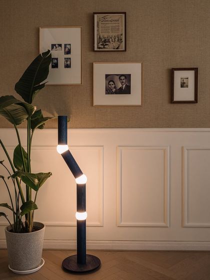 A close-up of the den's gallery wall, featuring the client's family photos. This is how we weave personal stories into the design.