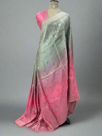 A unique shaded satin saree blending from pastel green to pink.