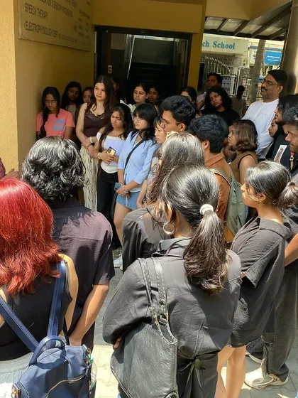The artist, Archana Hande, speaking to the students outside the gallery.