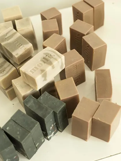 A collection of different soap batches, showcasing the variety of natural colors and textures.