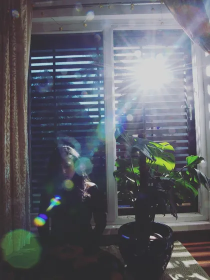 Finding a moment of peace through meditation. The simple act of sitting by a window, feeling the warmth of the sun, and turning your attention inward can be a powerful form of practice. This is what mindfulness is about: connecting with the present moment, just as it is.
