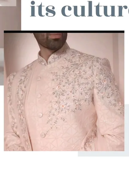 A close-up of the beautiful pastel pink sherwani, showcasing the intricate resham and zardosi work on the collar and front panel.