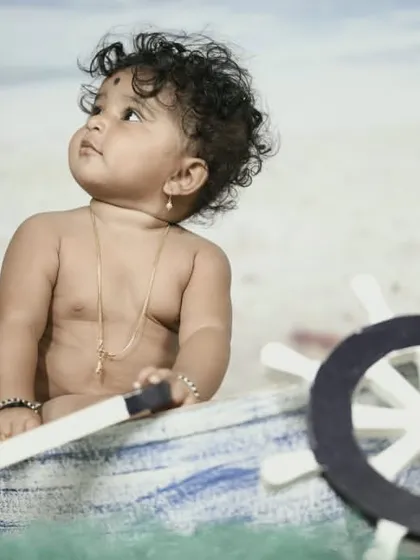 Explore our full nautical and beach-themed collection. These images showcase the variety of poses and angles possible with our boat prop, sand-colored flooring, and ocean backdrop.