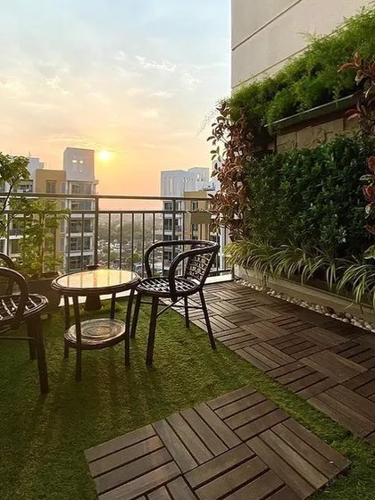 Even a small city balcony has great potential. Here, we combined a vertical garden with wooden deck tiles and artificial turf to create a cozy and beautiful sunset spot for our client.