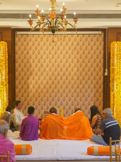 We believe in honoring traditions with beauty and grace. This serene puja setup, framed by vibrant walls of fresh marigolds, created a divine and peaceful atmosphere for a family ceremony.