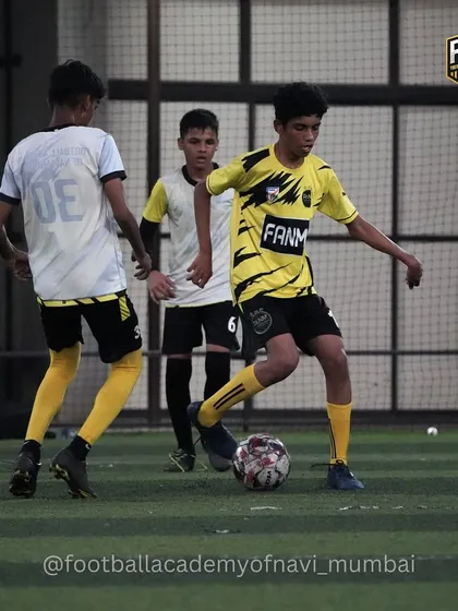 See our training in action. A player executes a sharp turn with the ball to move past a defender during a practice match. This is where we apply drill work to real game scenarios.