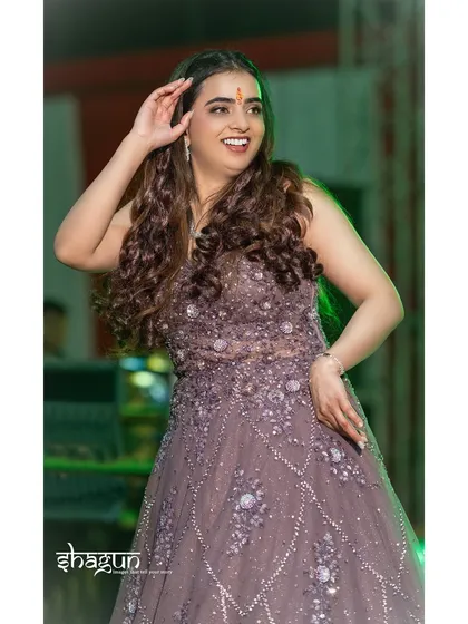 The rhythm of celebration, frozen in a perfect moment. A candid shot of a guest enjoying the sangeet performances.