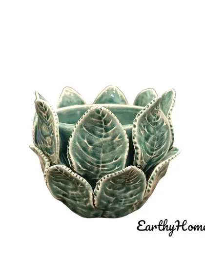 This beautiful ceramic tea light holder is shaped like a lotus flower, shown here in a calming green.