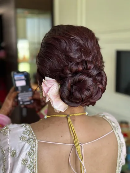 A different perspective of the burgundy bridal bun, showing how the rose is tucked in.