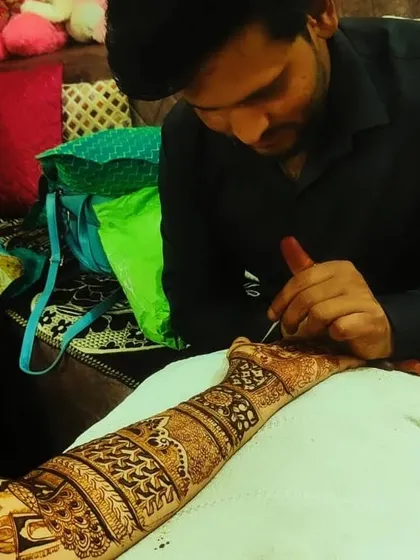 This is me in my element, focused on creating the perfect design. I bring all my experience and concentration to every single bride's mehndi.