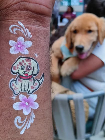 A custom dog portrait tattoo next to the furry friend who inspired it. I love creating personalized art for pet lovers.