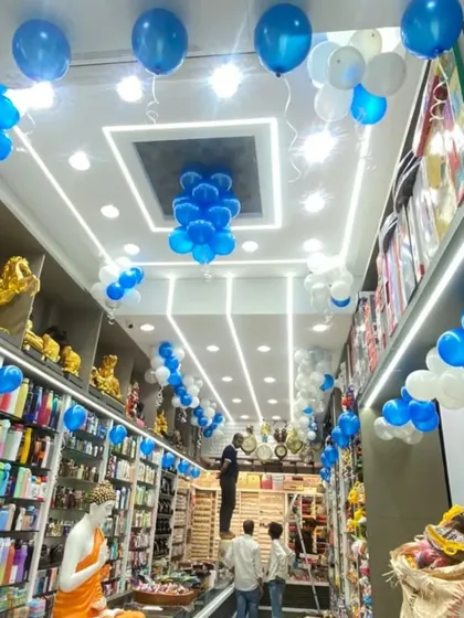 The interior of the "Giftie" shop decorated with blue and white balloon bunches on the ceiling to continue the festive opening theme.