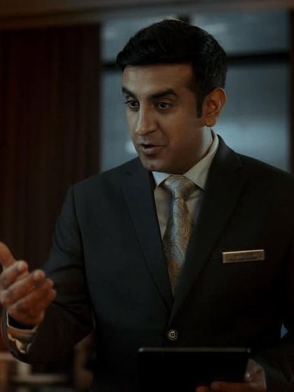 I styled this actor as a formal and slightly intimidating hotel manager to represent the confusing jargon of the financial world.